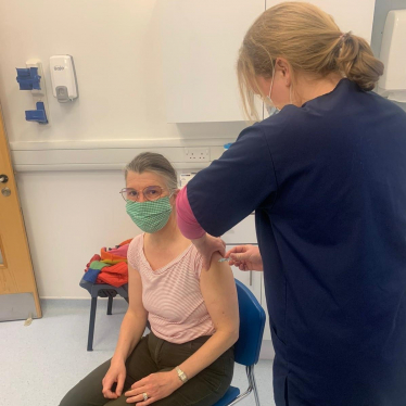 Rachel receiving her COVID vaccination.